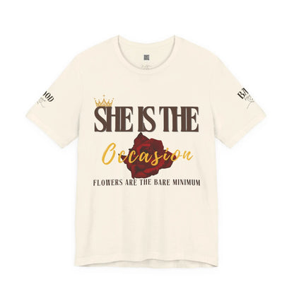 Soft pink "She Is The Occasion" women's T-shirt by Printify featuring empowering self-love message and luxury aesthetic.