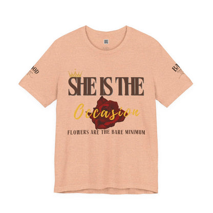 Soft pink "She Is The Occasion" women's motivational T-shirt by Printify, featuring empowering self-love message and luxurious aesthetic.