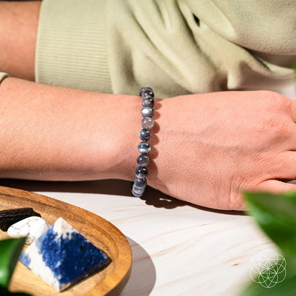 Black moonstone bracelet by Conscious Items featuring the Empath’s Cord Cutter design, showcasing smooth, polished stones on a delicate cord.