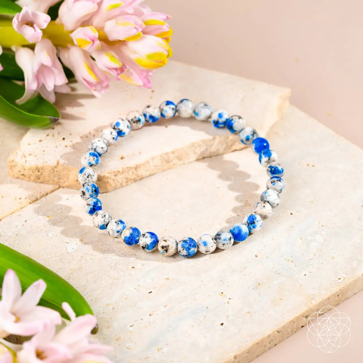 Close-up of a 6mm K2 Stone bracelet from Conscious Items, featuring smooth, round stones with a natural, earthy appearance.