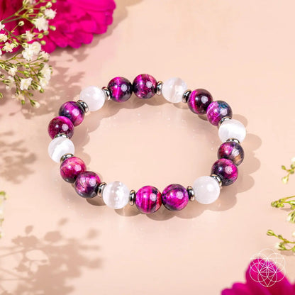 Pink galaxy tiger’s eye bracelet from Conscious Items with beaded design and adjustable cord, showcasing a vibrant, cosmic-inspired jewelry piece.
