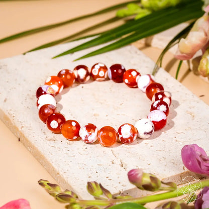 Feminine Force Carnelian Orca Agate bracelet by Conscious Items featuring vibrant orange and black band with polished stone beads.
