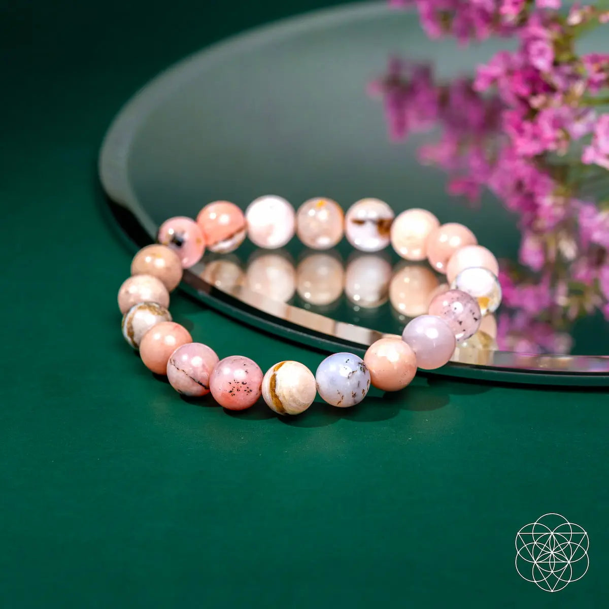 Peruvian Pink Opal bracelet by Conscious Items featuring pink gemstone beads and a silver clasp on a neutral background.