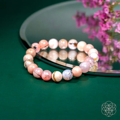 Peruvian Pink Opal bracelet by Conscious Items featuring pink gemstone beads and a silver clasp on a neutral background.