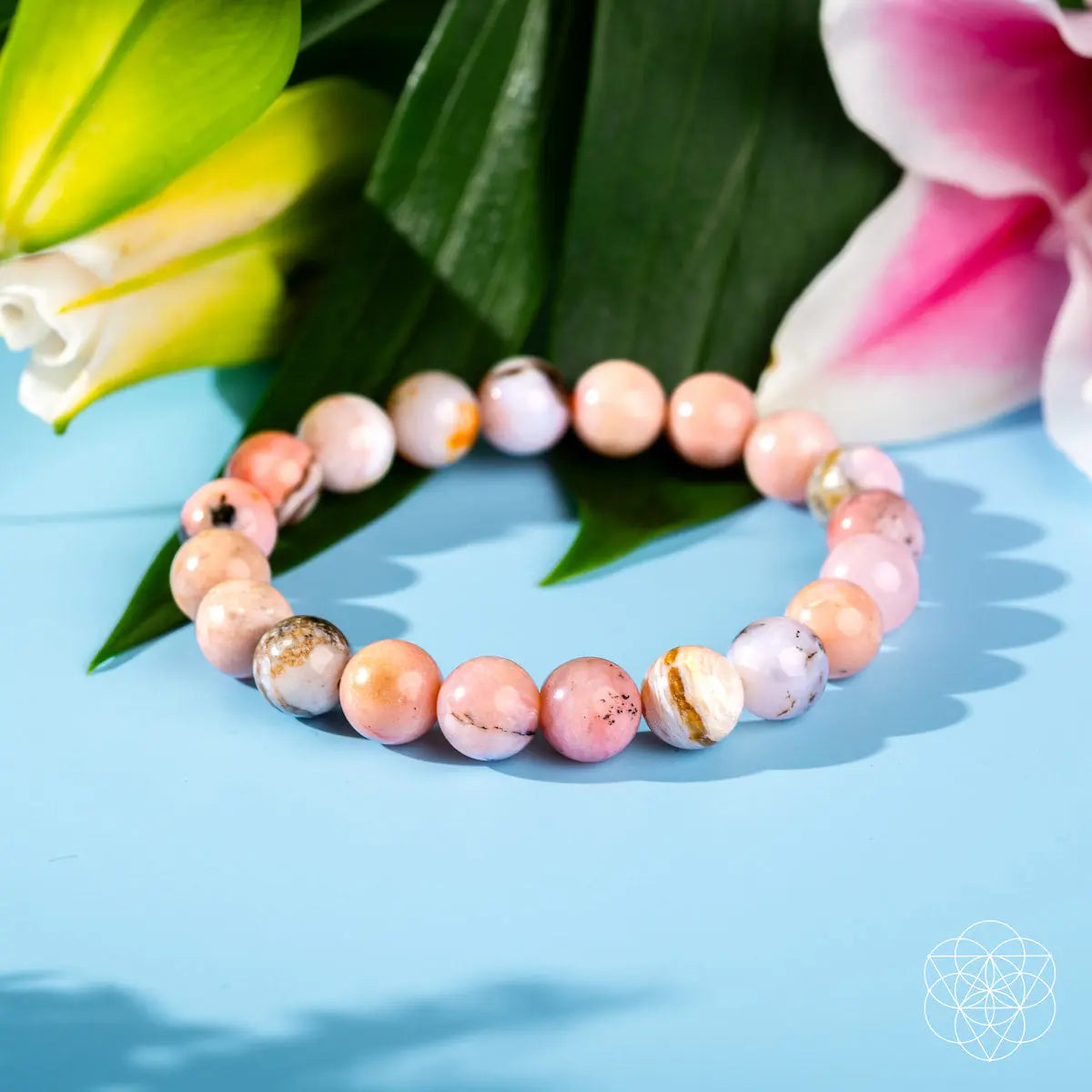 Peruvian pink opal bracelet from Conscious Items featuring smooth, polished pink stones on a delicate elastic band.