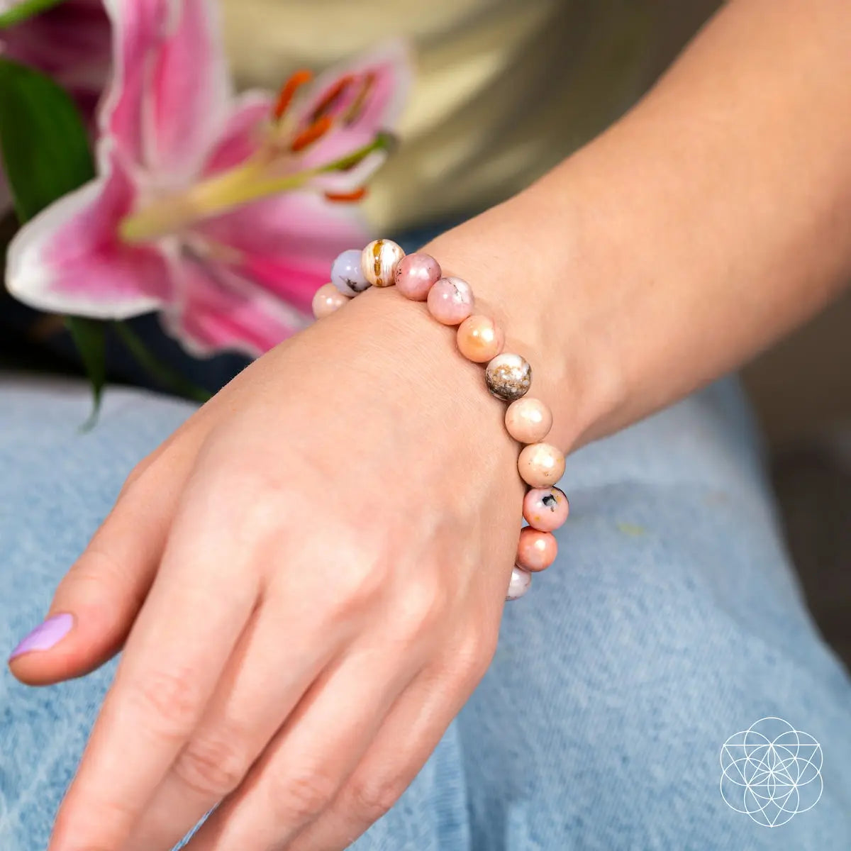 Peruvian Pink Opal bracelet by Conscious Items featuring polished pink stone beads and a silver clasp.