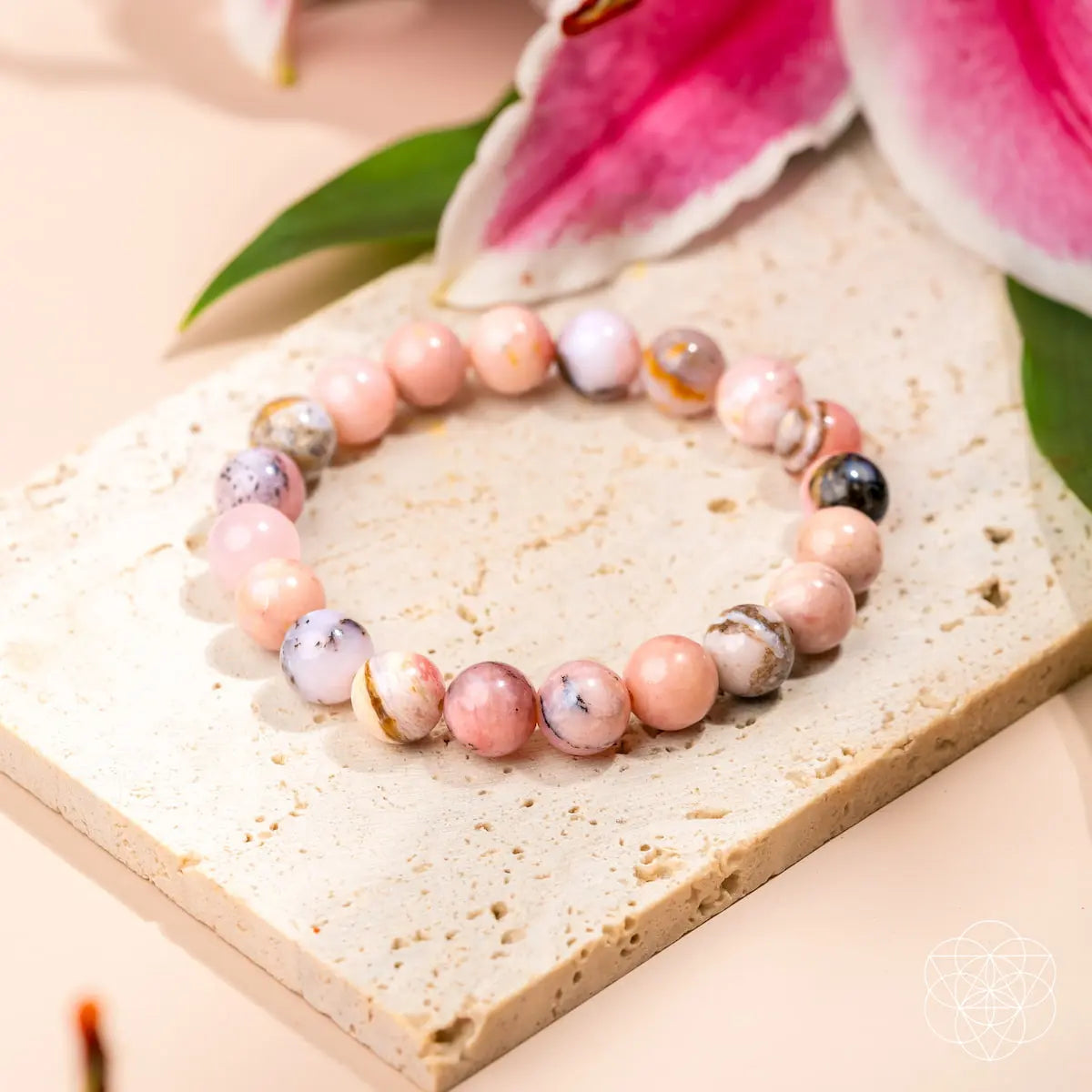 Peruvian Pink Opal bracelet from Conscious Items, featuring smooth pink gemstone beads on a delicate elastic cord.