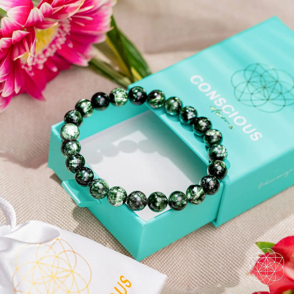 Seraphinite bracelet of transformation by Conscious Items featuring rare angel energy, with intricate green and silver-toned stone beads.