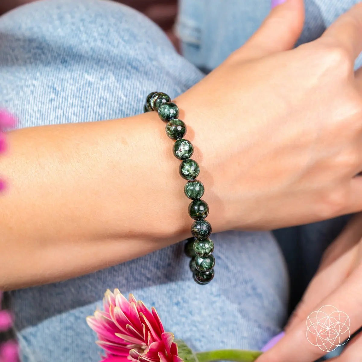 Seraphinite bracelet of transformation from Angel Energy by Conscious Items, featuring green, feather-like stone with silver accents.