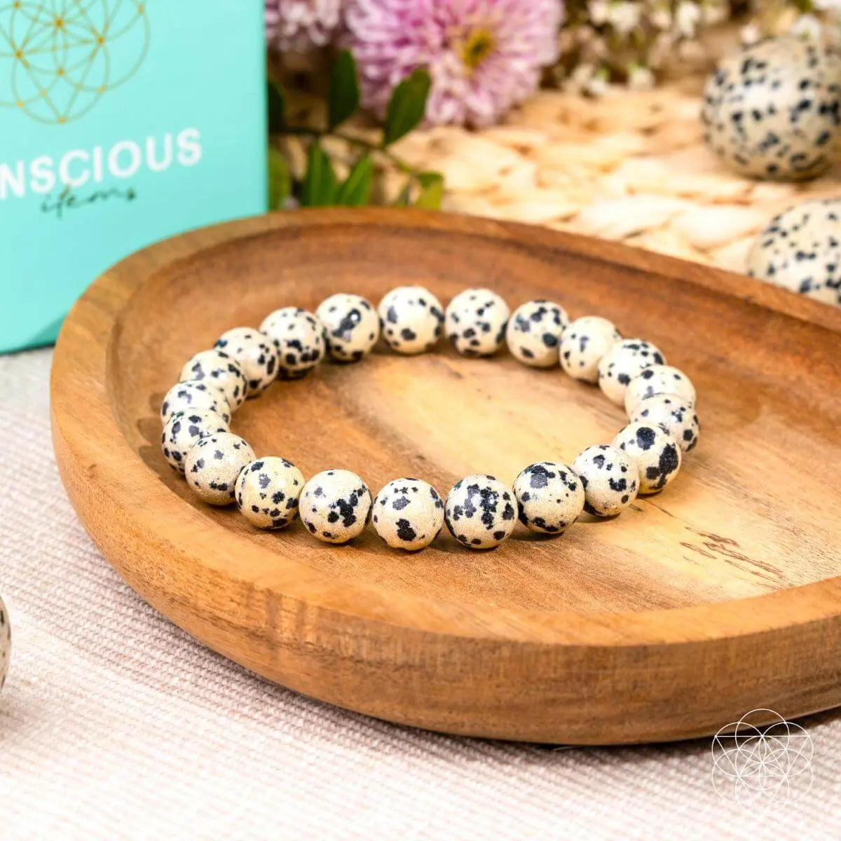 Dalmatian Jasper bracelet from Conscious Items featuring spotted stone beads and a stretchy elastic design.