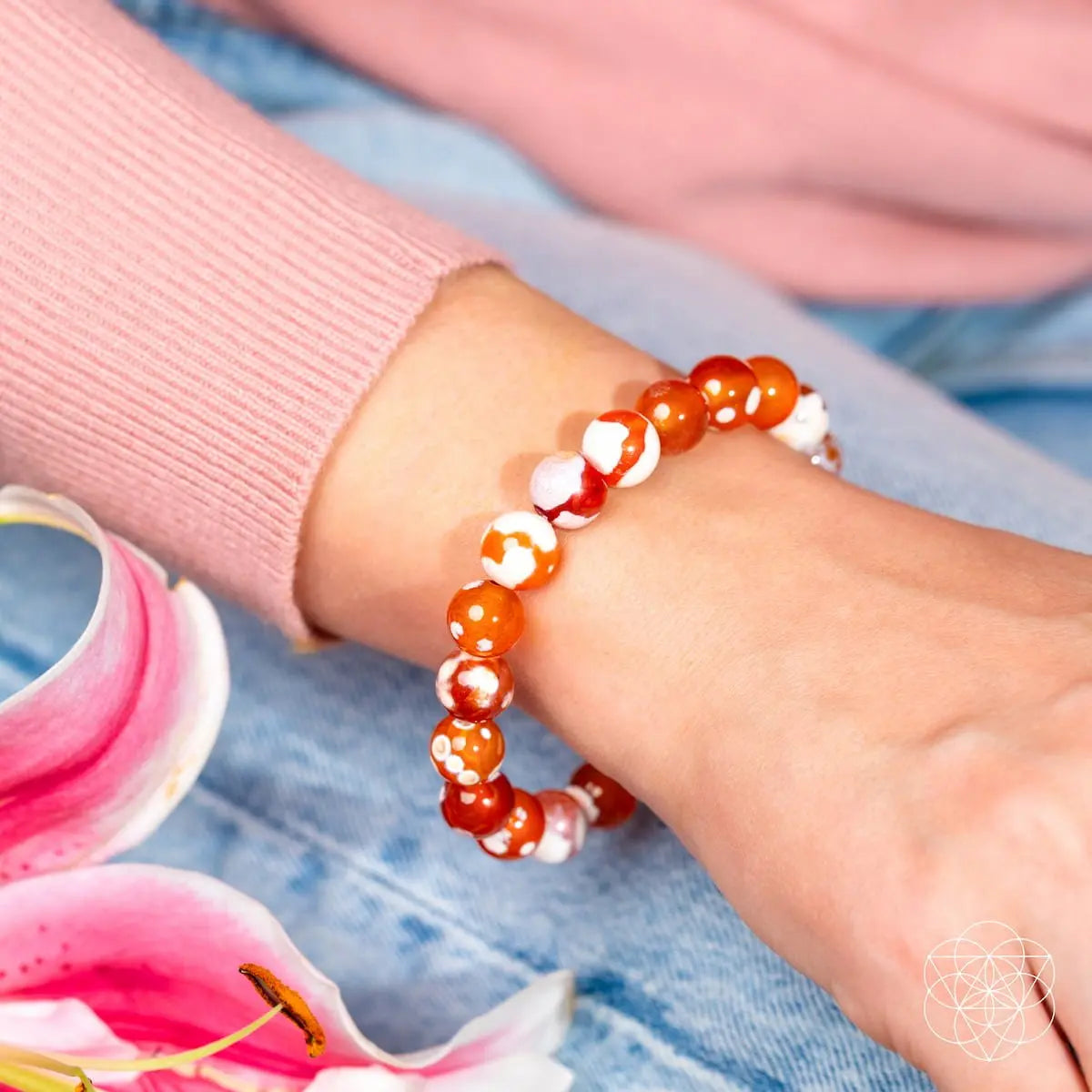 Feminine Force Carnelian Orca Agate bracelet by Conscious Items featuring polished orange and black patterned agate beads.
