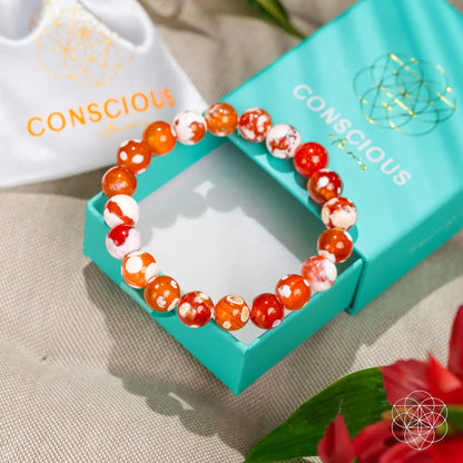 Feminine Force Carnelian Orca Agate bracelet by Conscious Items featuring vibrant orange and black patterned agate stones on a stretchy band.