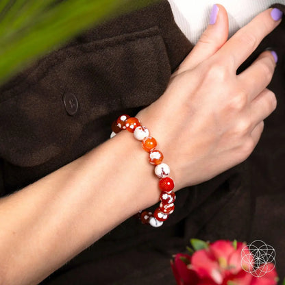 Feminine Force Carnelian Orca Agate bracelet featuring vibrant orange and black stone beads from Conscious Items.
