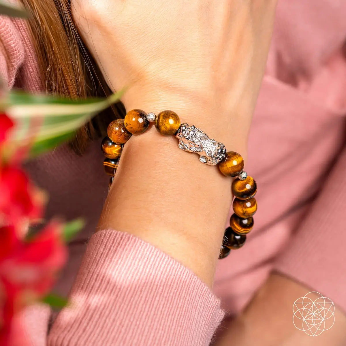 Conscious Items Fortune Flows Tiger’s Eye and Pixiu bracelet featuring polished beads and intricate charm for good luck.