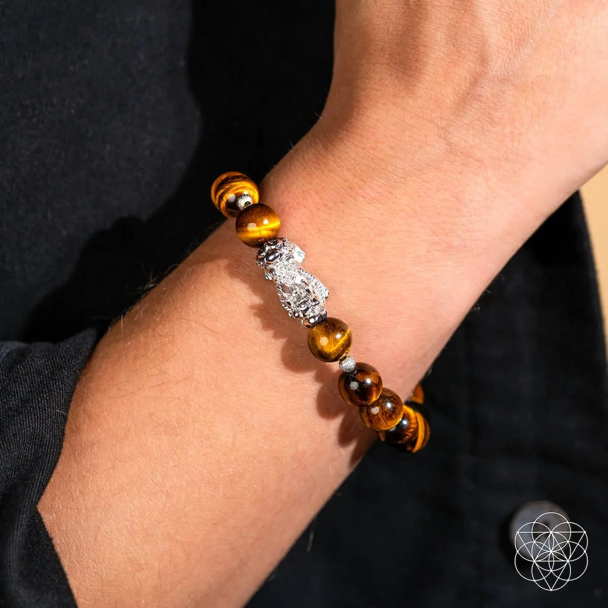 Fortune Flows Tiger’s Eye and Pixiu bracelet by Conscious Items featuring polished tiger’s eye beads and a Pixiu charm.