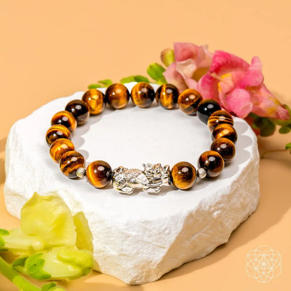 Tiger’s Eye and Pixiu bracelet from Conscious Items, featuring a beaded design with a lucky charm and natural gemstone accents.