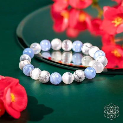 Close-up of The Empath’s Trio Daily Reset Bracelet by Conscious Items showing layered bracelets with charms and beads.